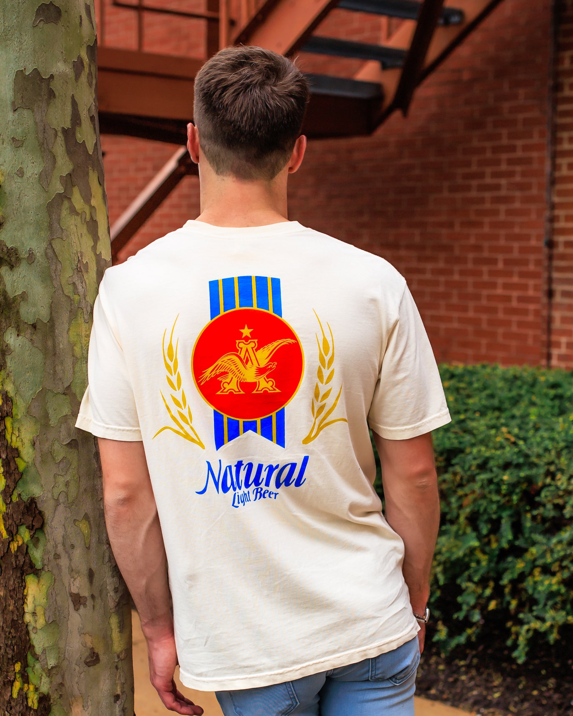 Back view of model wearing Natural Light Throwback T-Shirt