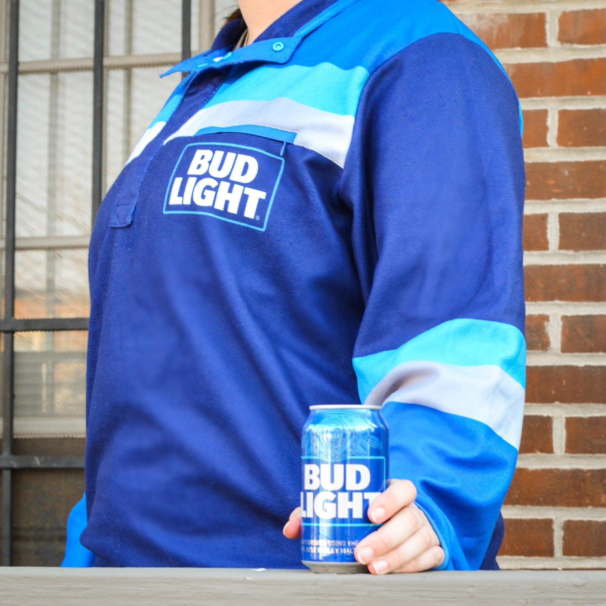 woman wearing blue bud light resort 1/4 snap fleece while holding a bud light can