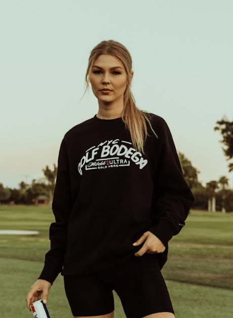 Lifestyle of woman wearing black Golf bodega crewneck