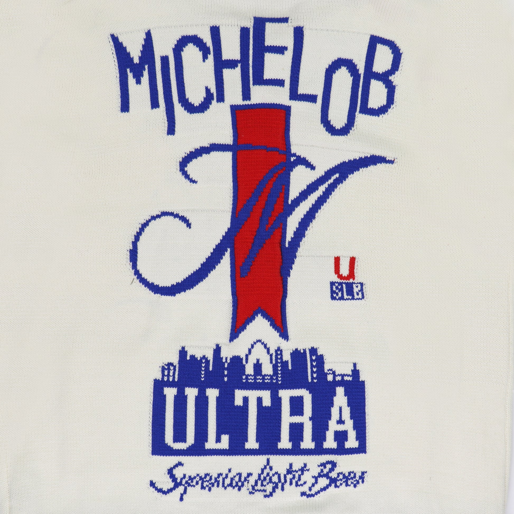 close up detail on back of sweater, michelob ultra ribbon with city below