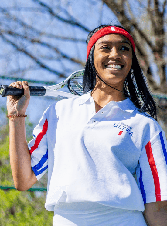 woman wearing white michelob ultra 1980 polo shirt