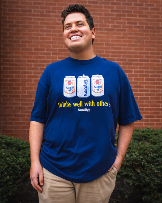 Model wearing Natural Light "Drinks well with others" T-Shirt