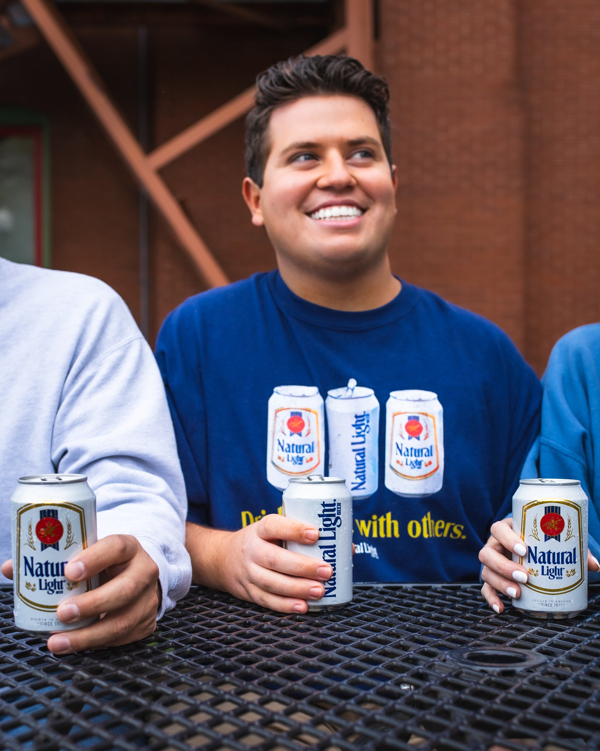 Model wearing Natural Light "Drinks well with others" T-Shirt