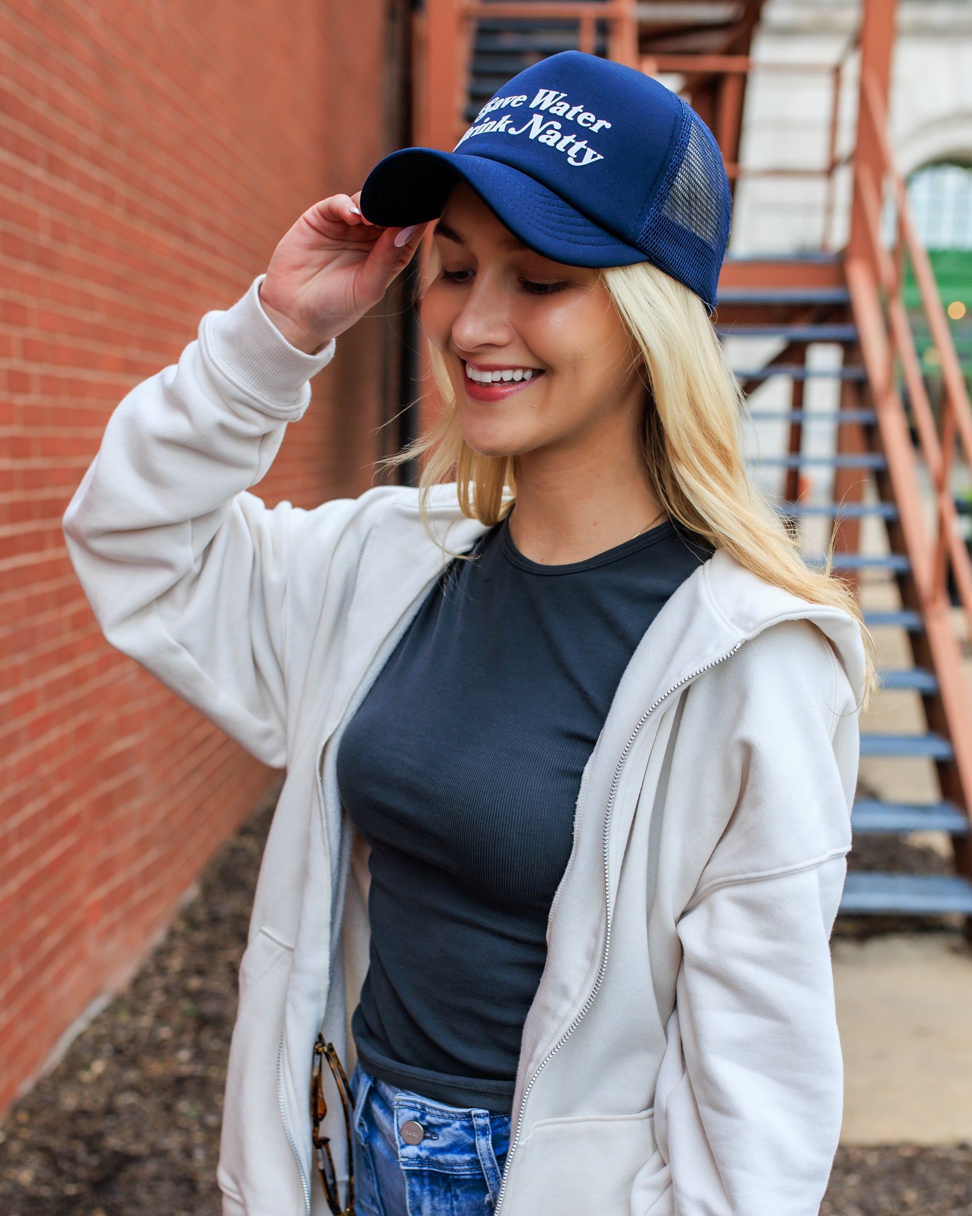 Model wearing "Save Water Drink Natty" Trucker Hat