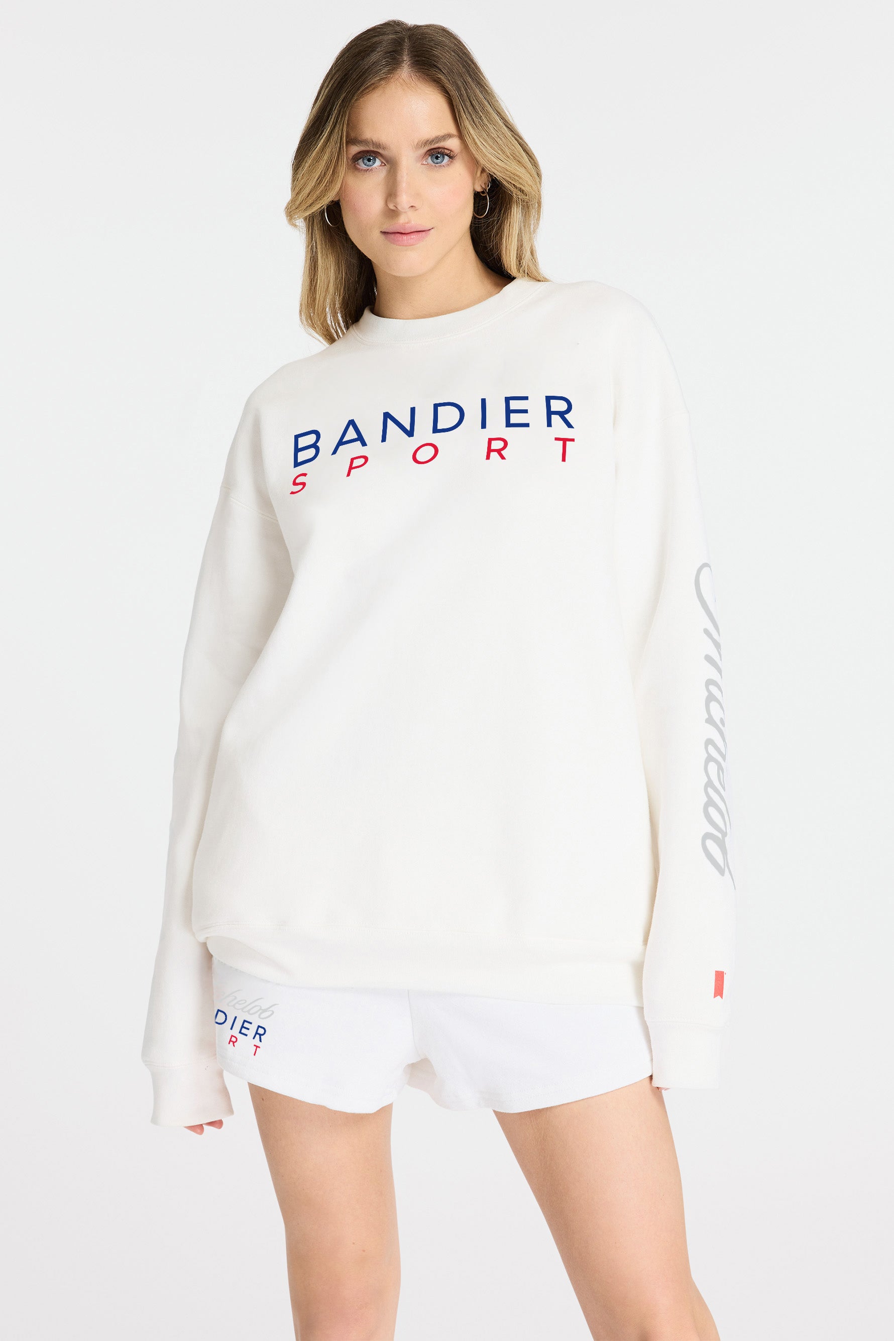 Front view of model wearing Michelob ULTRA x BANDIER Sweatshirt, "Bandier Sport" across the chest, "Michelob" on left sleeve.