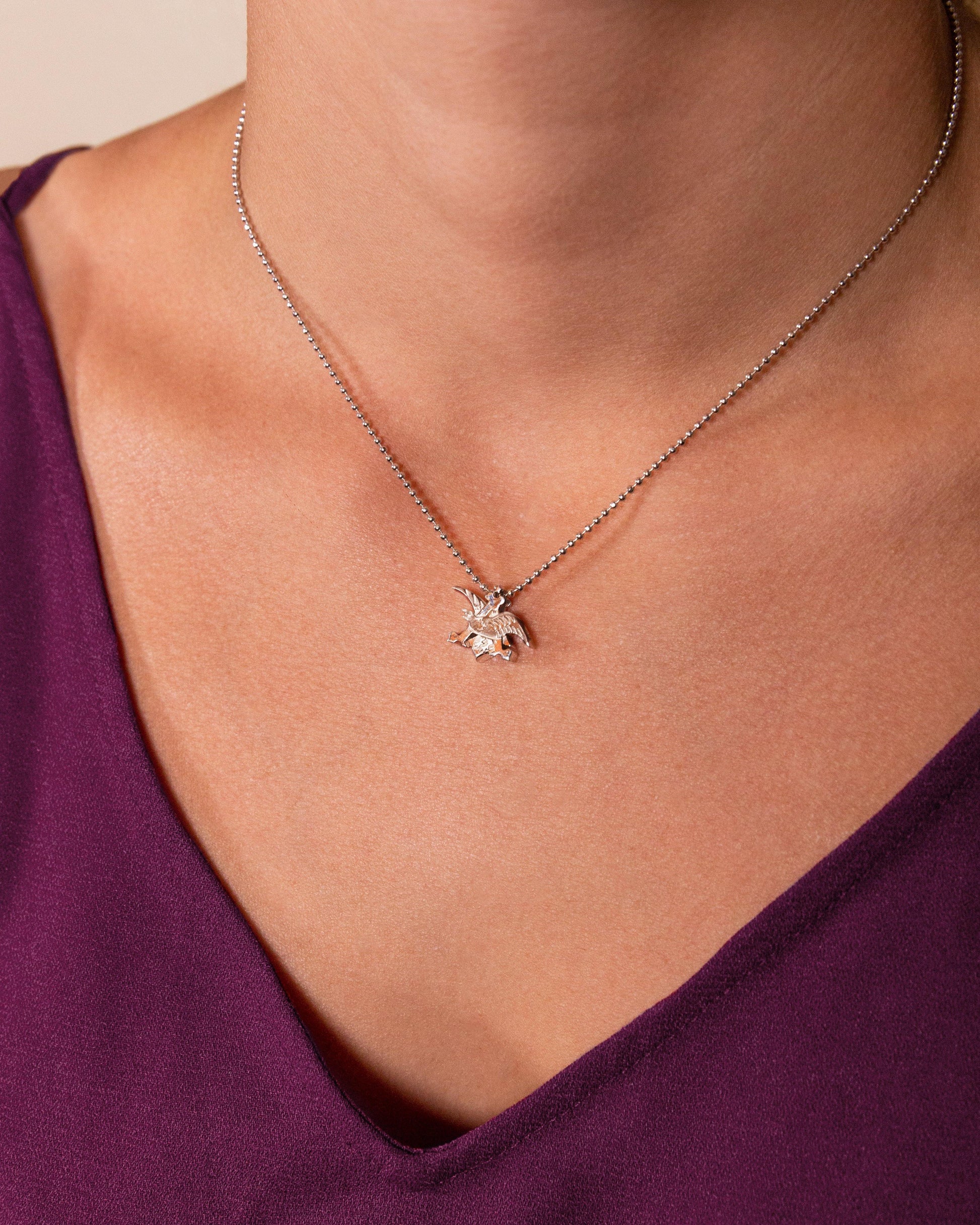 From Jewelry designer Alex Woo a 14 carat silver anheuser busch and eaglenecklace, 16 inches long