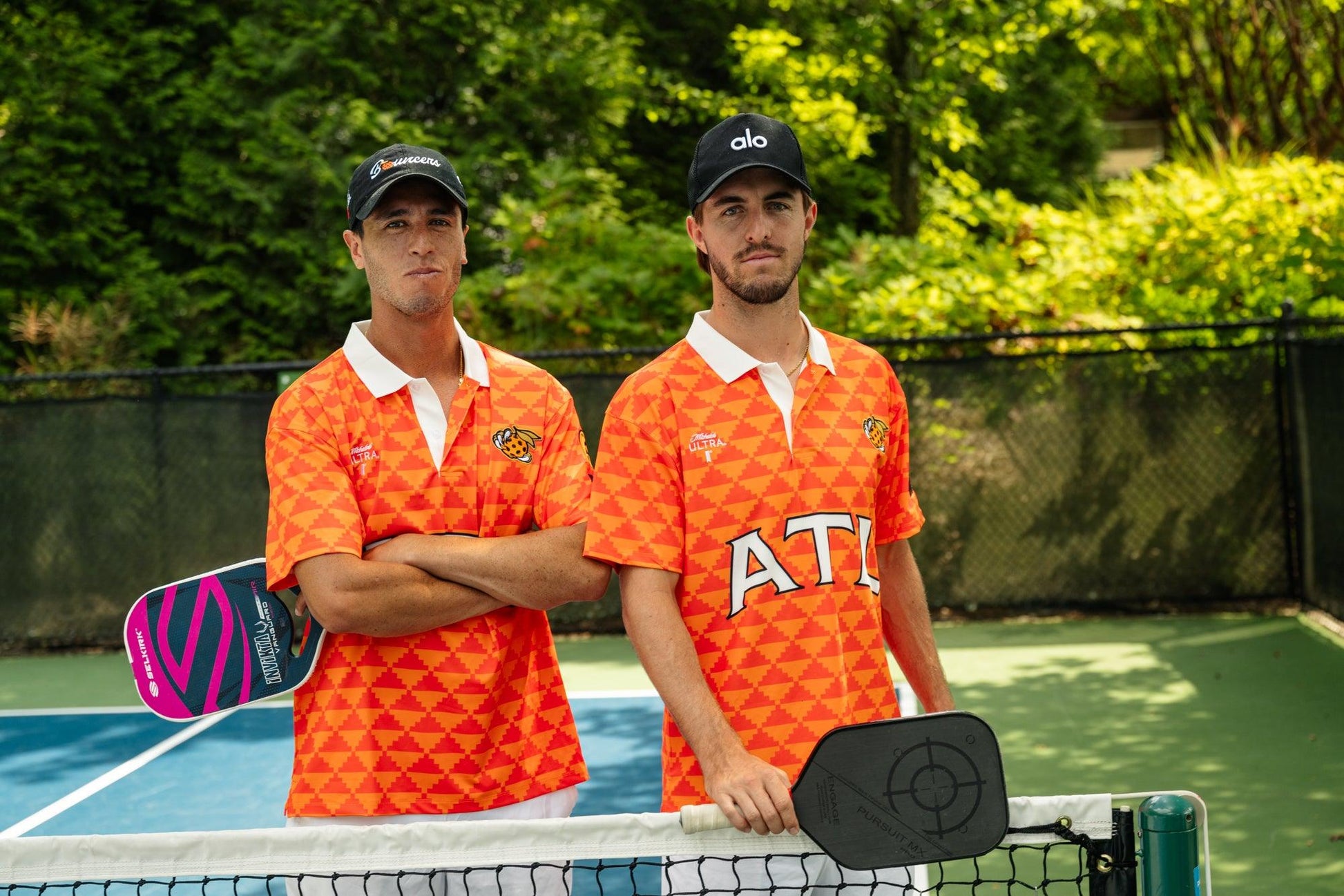 Two men holding pickleball paddles and wearing Atlanta Bouncers Devereux Jerseys