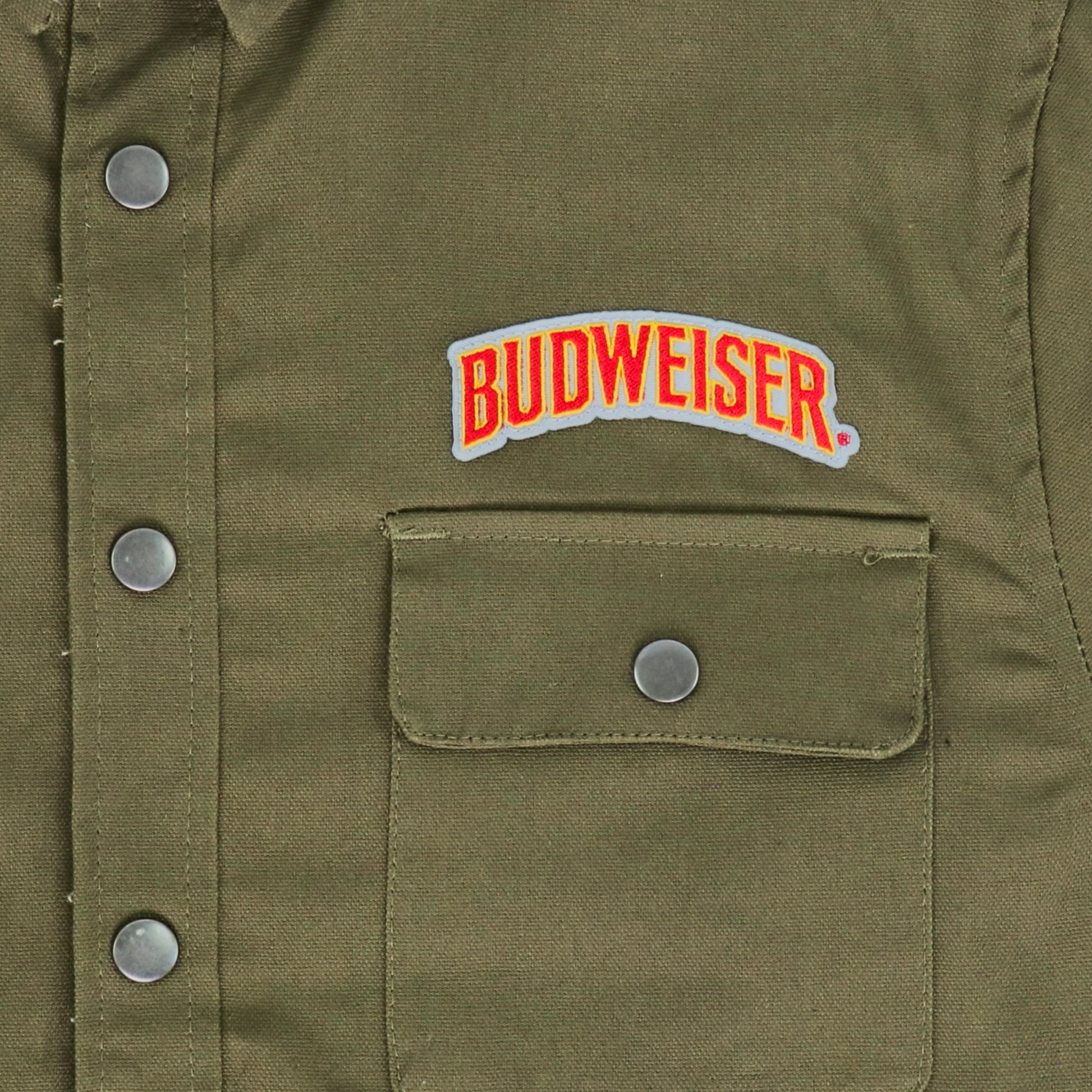 Close up of embroidered Budweiser logo on front of jacket above pocket
