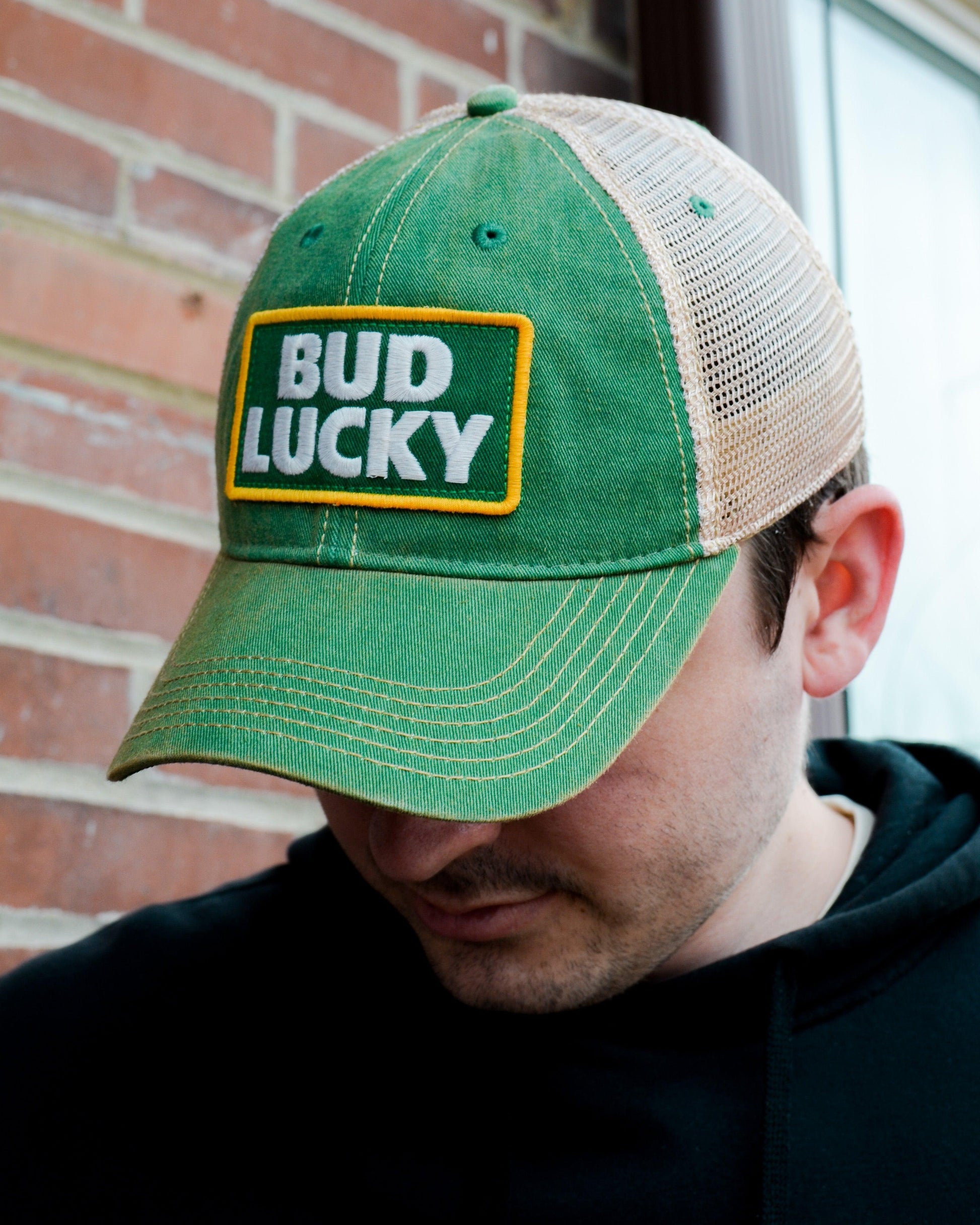 man wearing bud lucky hat 