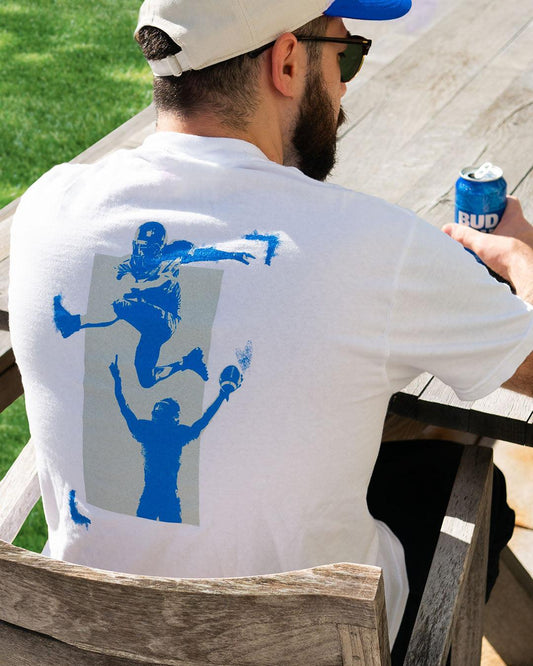 Back view of model wearing shirt, 2 Football players, one hurdling another