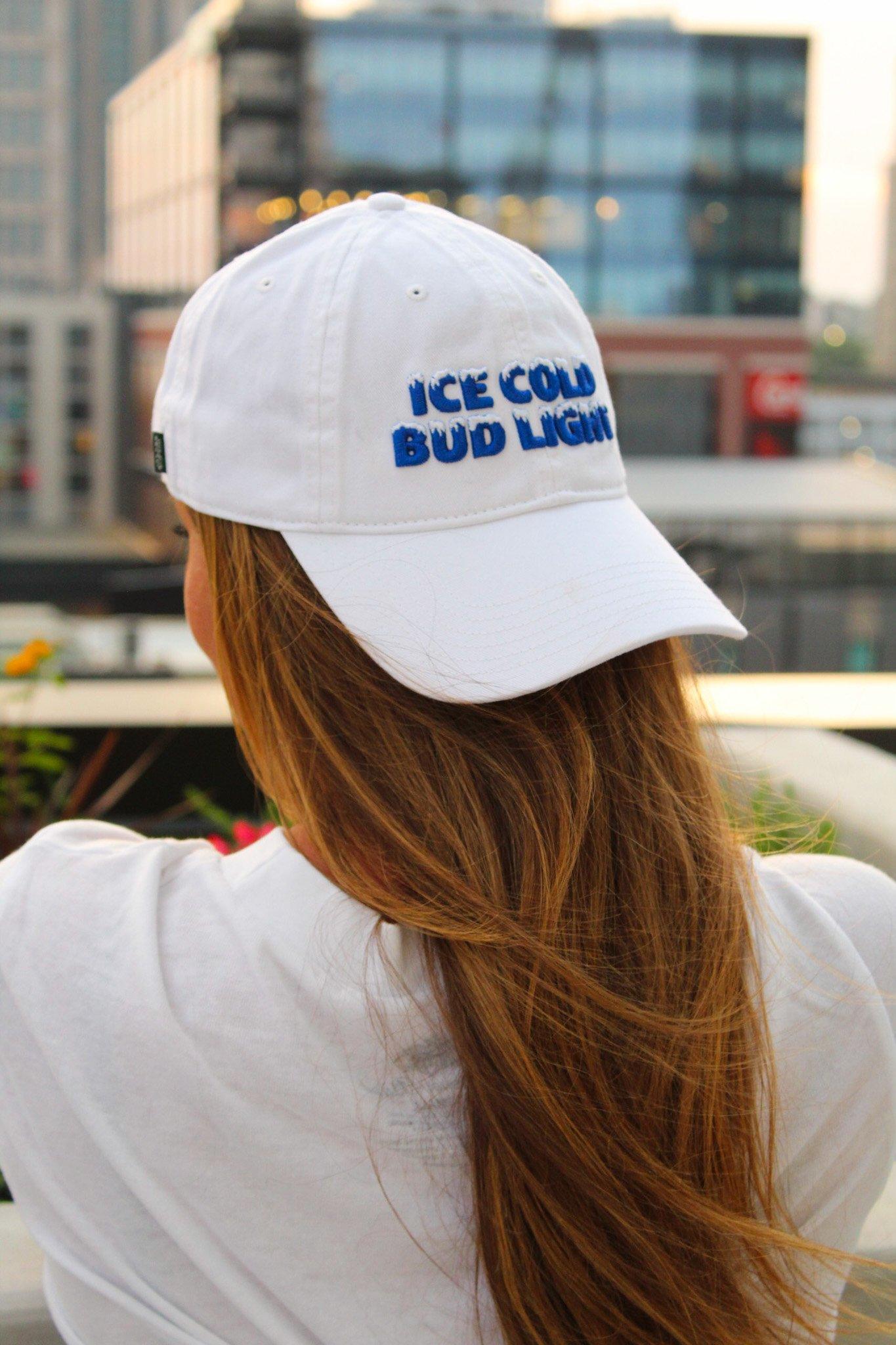 woman wearing white hat that says ice cold bud light