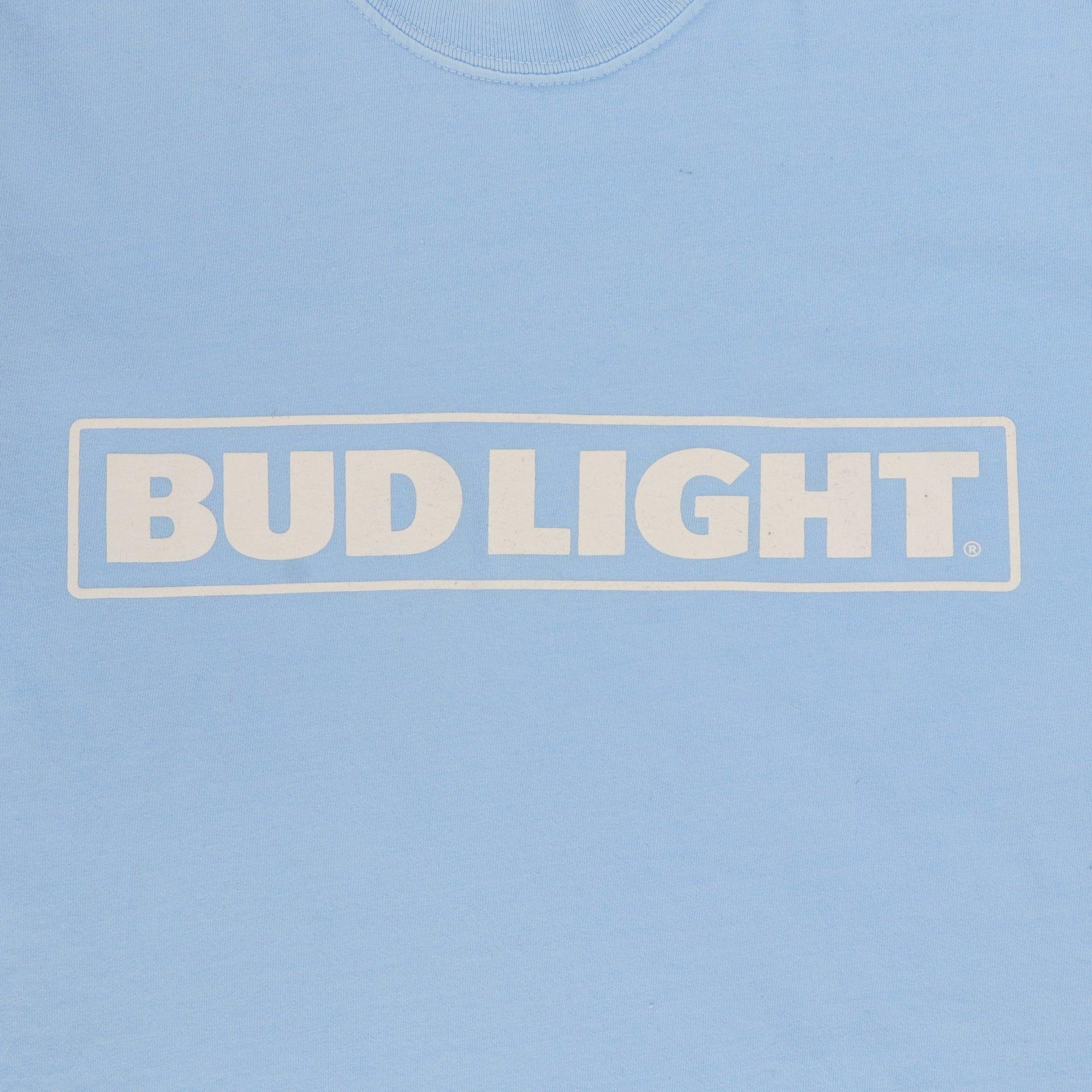 Close up of white Bud Light horizontal logo on light blue t-shirt