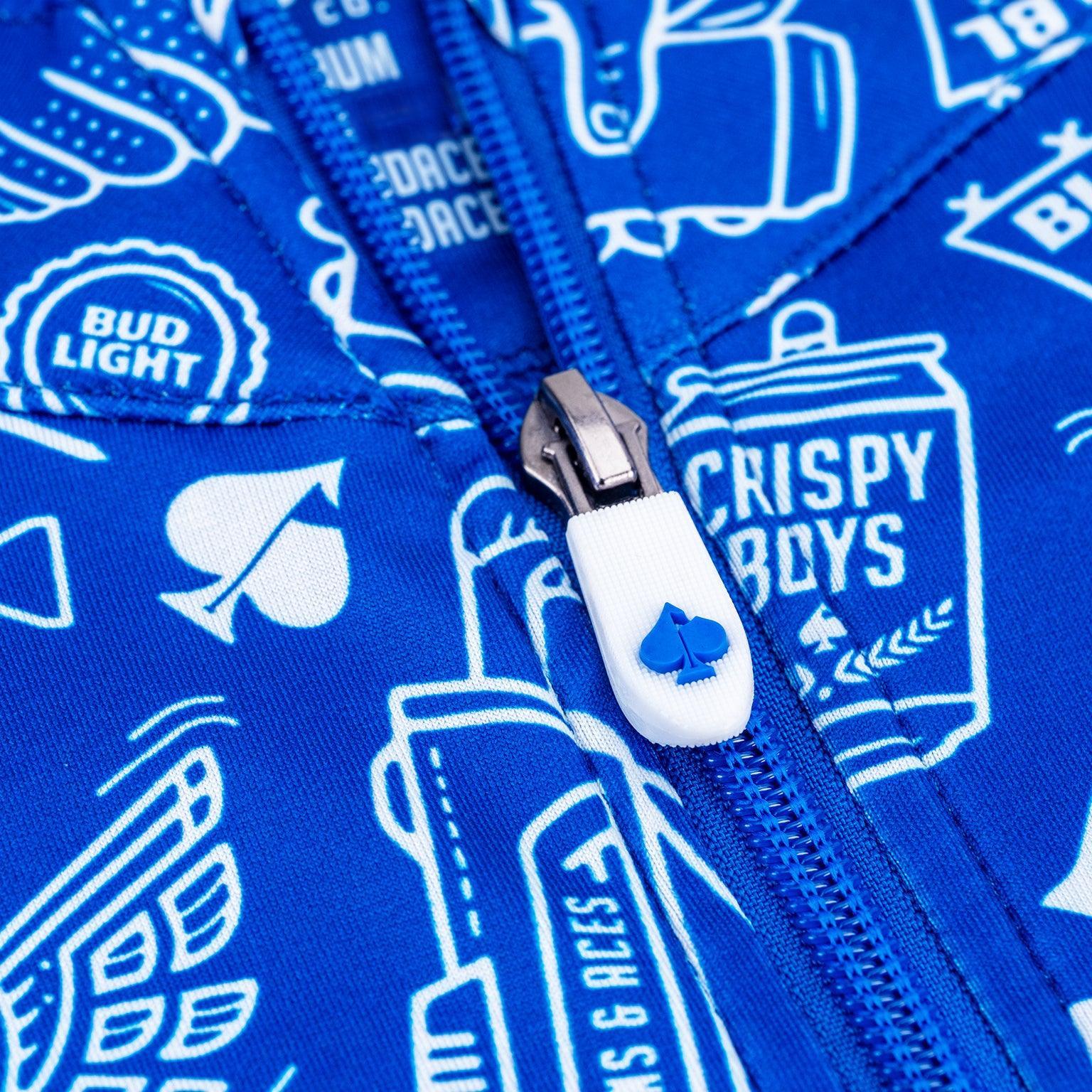 Close up of detailing on zipper. white zipper with blue spade on zipper.