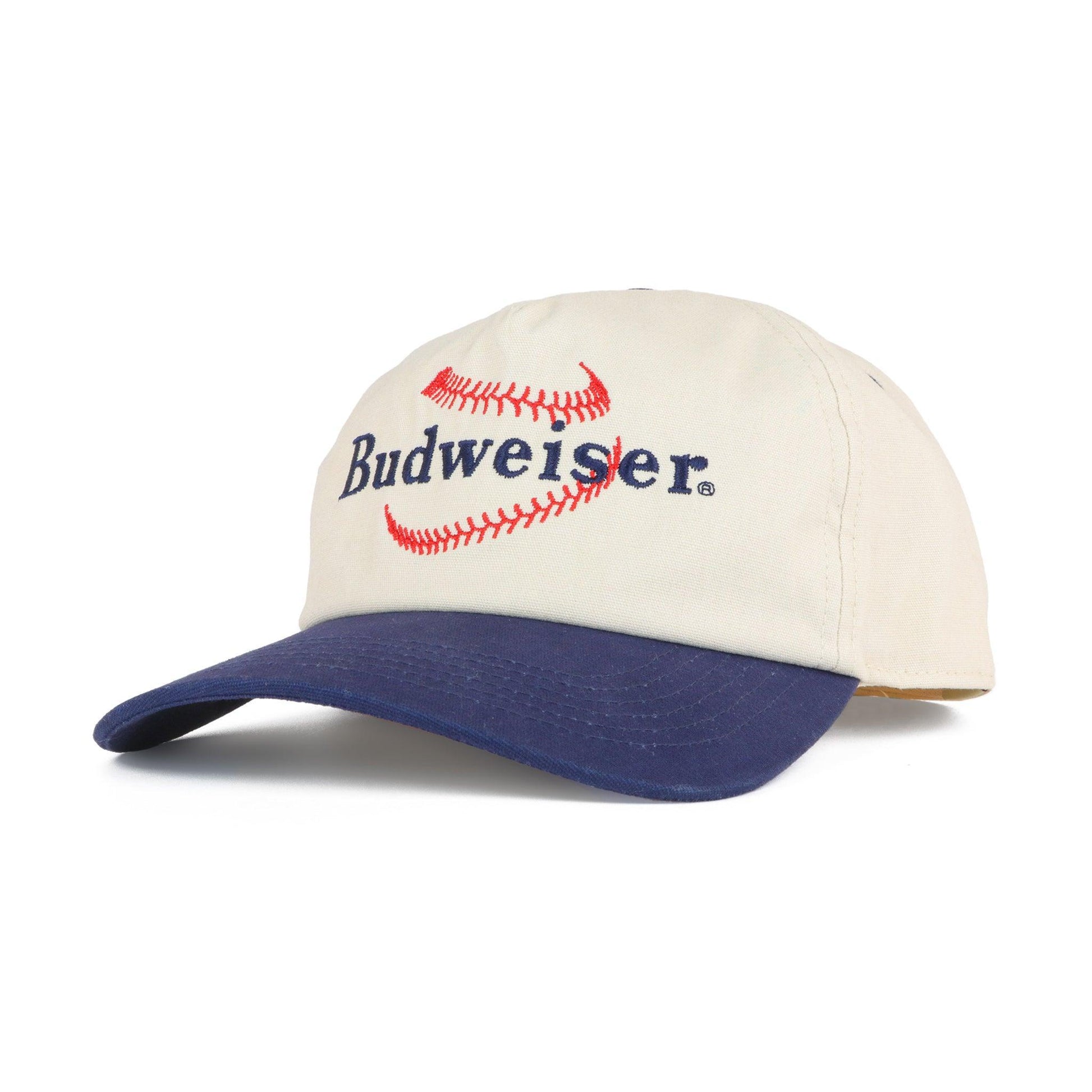 Cream colored hat with navy bill. Budweiser embroidered logo with baseball stitches around the name Budweiser