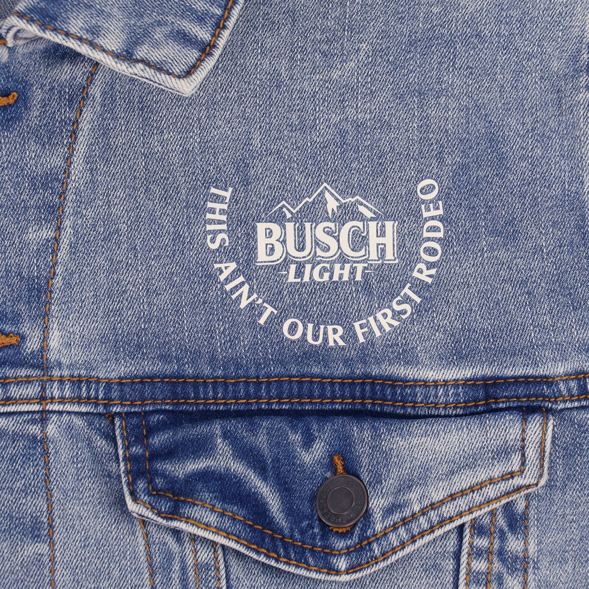 Close up of front logo on Denim Jacket "This Ain't Our First Rodeo"