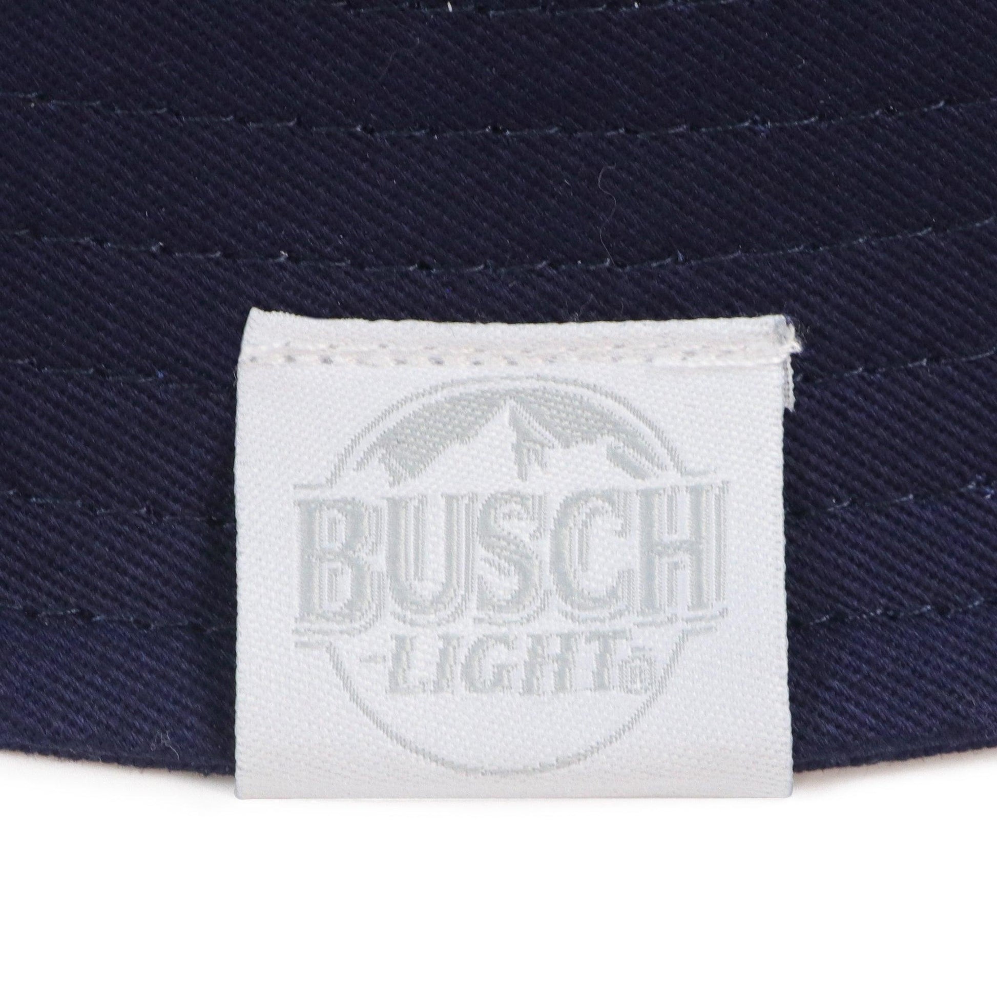 Close up of Busch light logo tag on brim of hat.