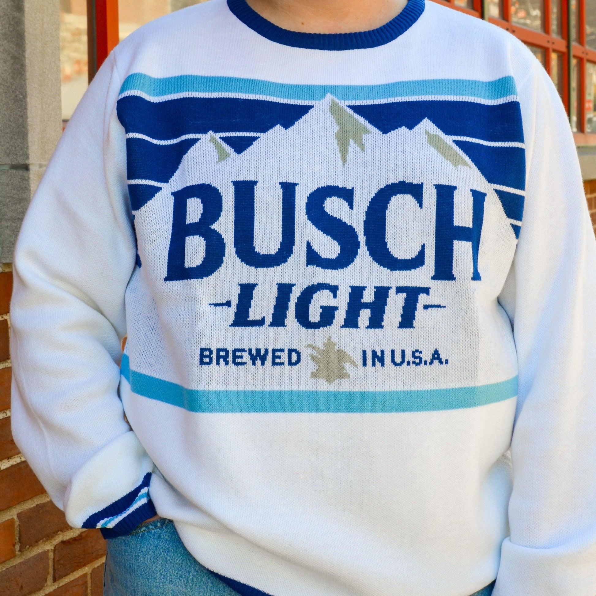 Model wearing Busch Light holiday sweater, front view