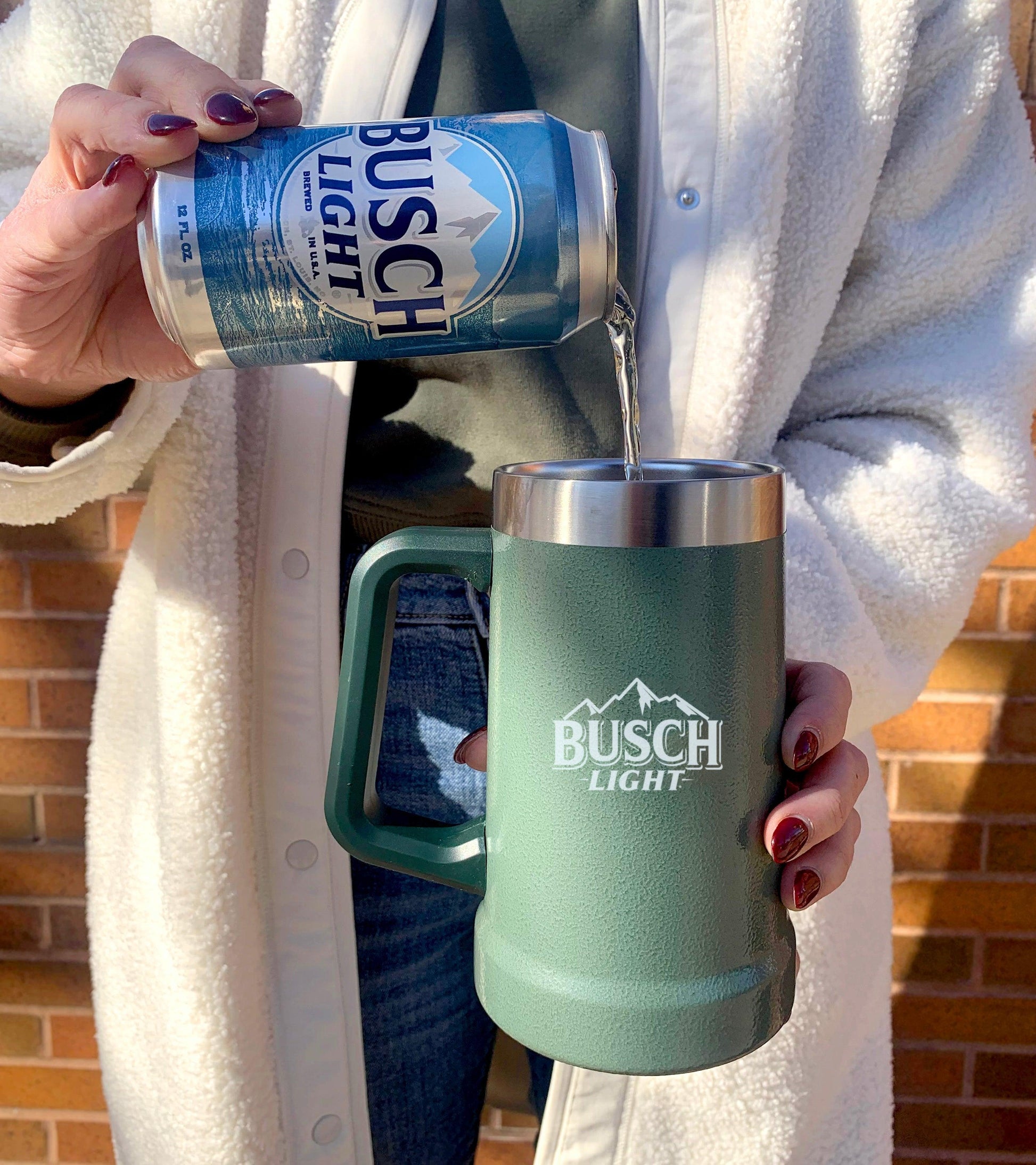 Woman pouring Busch Light into Stanley Stein