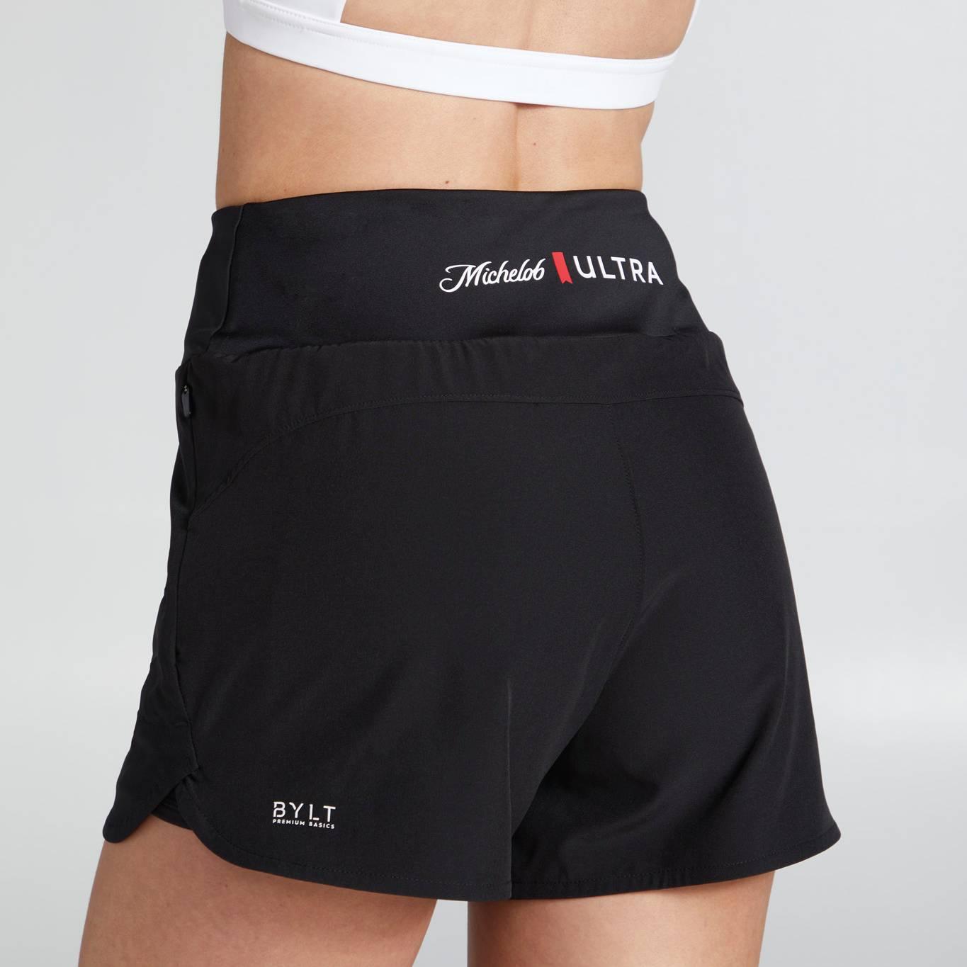 back view of womens flow shorts with BYLT logo on the bottom back left thigh and Michelob ULTRA logo on back center waistband