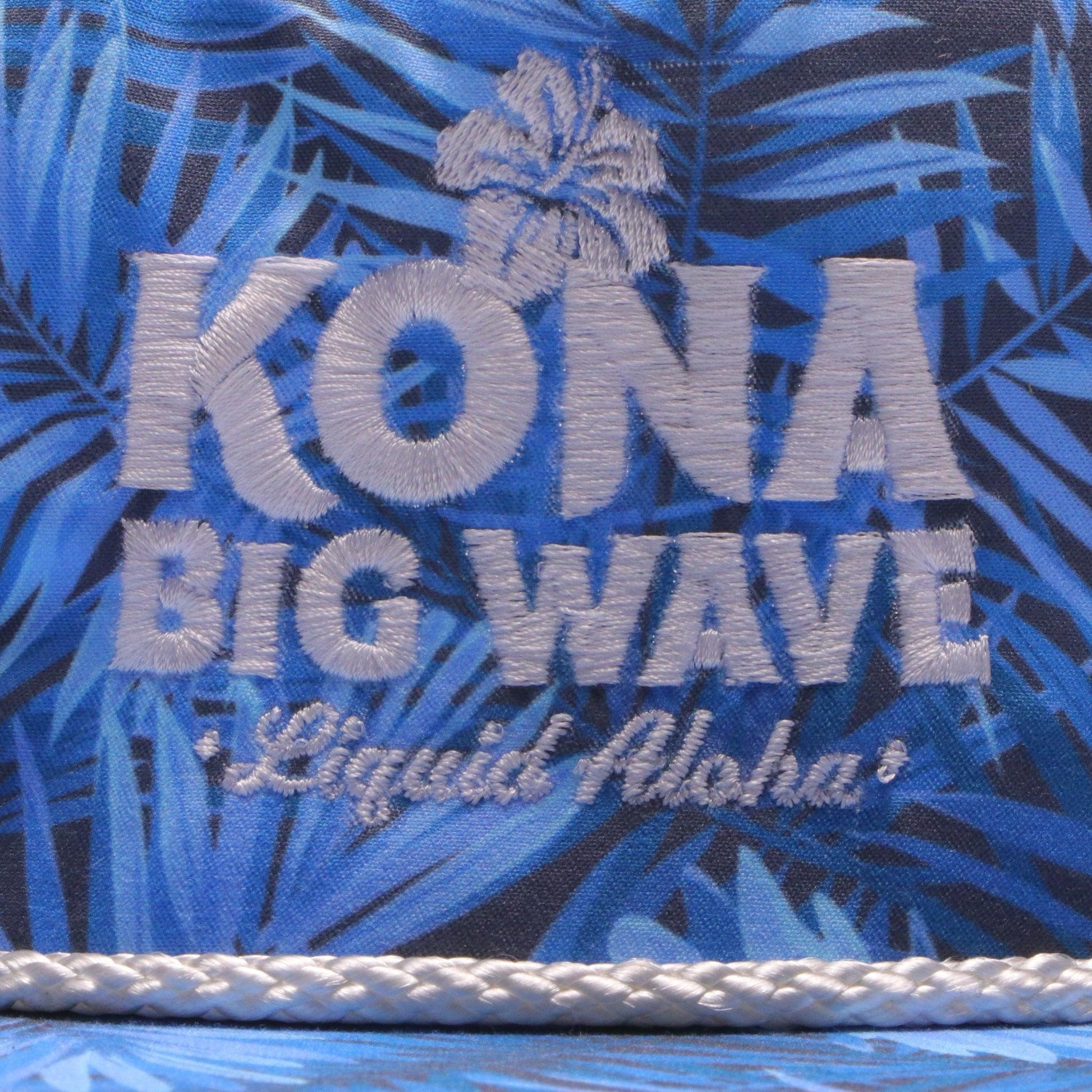 close up of front panel decoration of hat. white embroidered Kona Big Wave Liquid Aloha logo