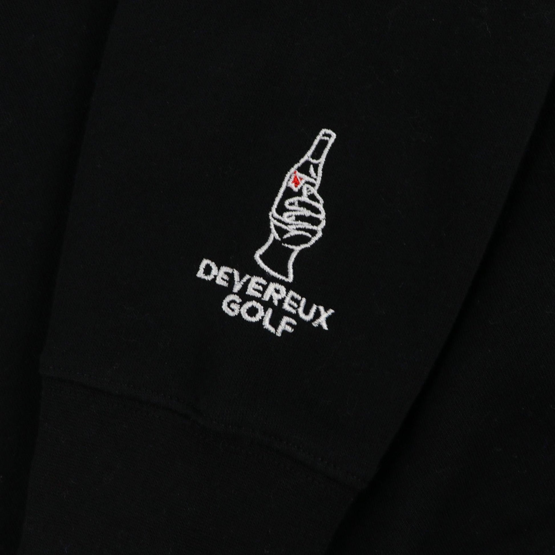 Embroidered Devereaux golf with hand holding bottle of ULTRA. this is featured on lower sleeve by cuff.