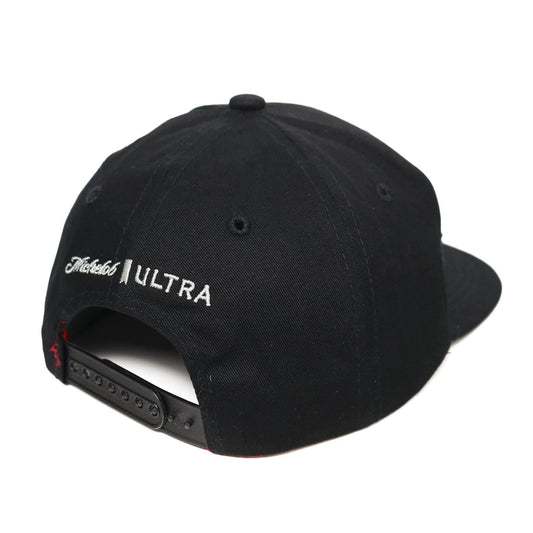 black michelob ultra flat bill hat with the ultra ribbon on the front left side of the hat and the michelob ultra logo on the back above the snapback