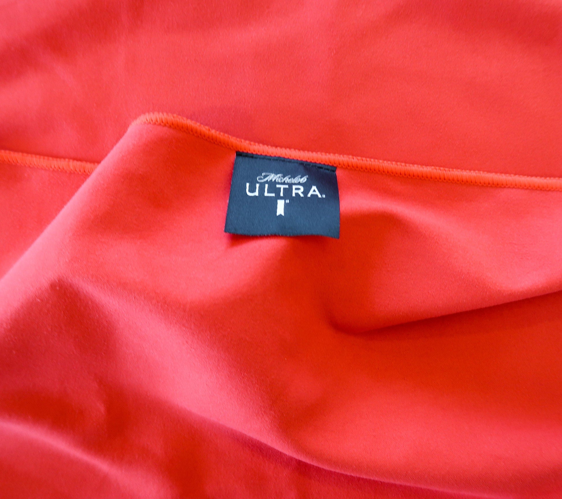 michelob ultra towel upclose of the black tag with logo 