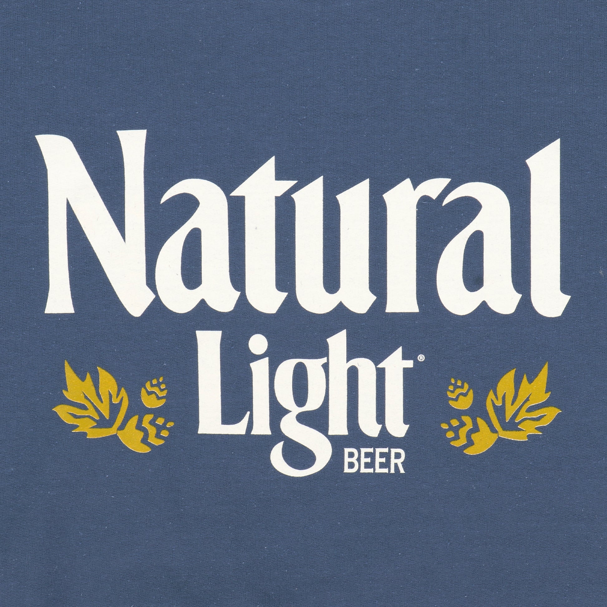 Close up of Natural Light logo on navy crewneck