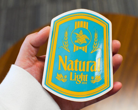 Hand Holding the Natural Light Vintage Blue Sticker