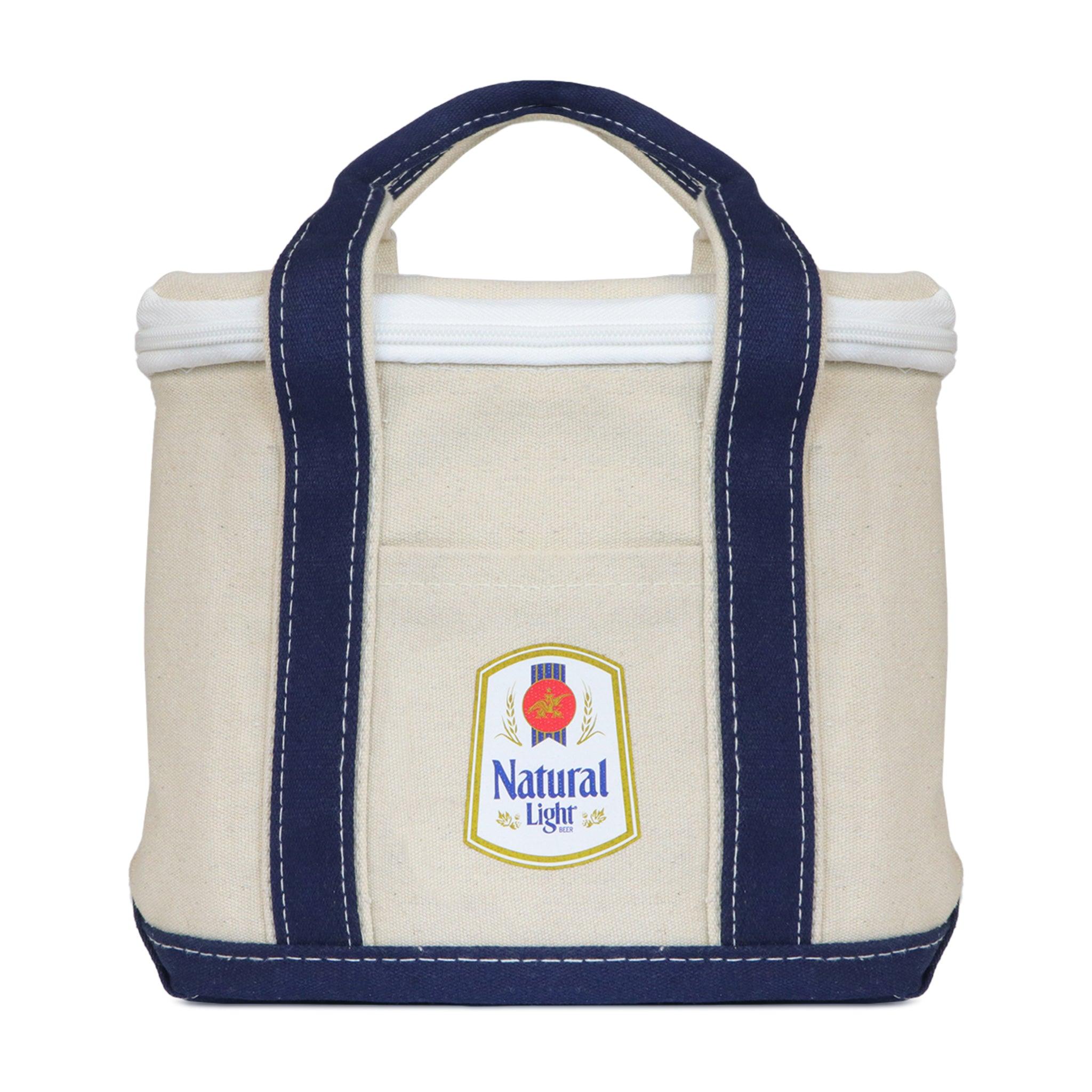 Oatmeal colored canvas 12 can cooler with navy bottom and navy handles with Natural light vintage logo on front pocket. top zipper enclosure