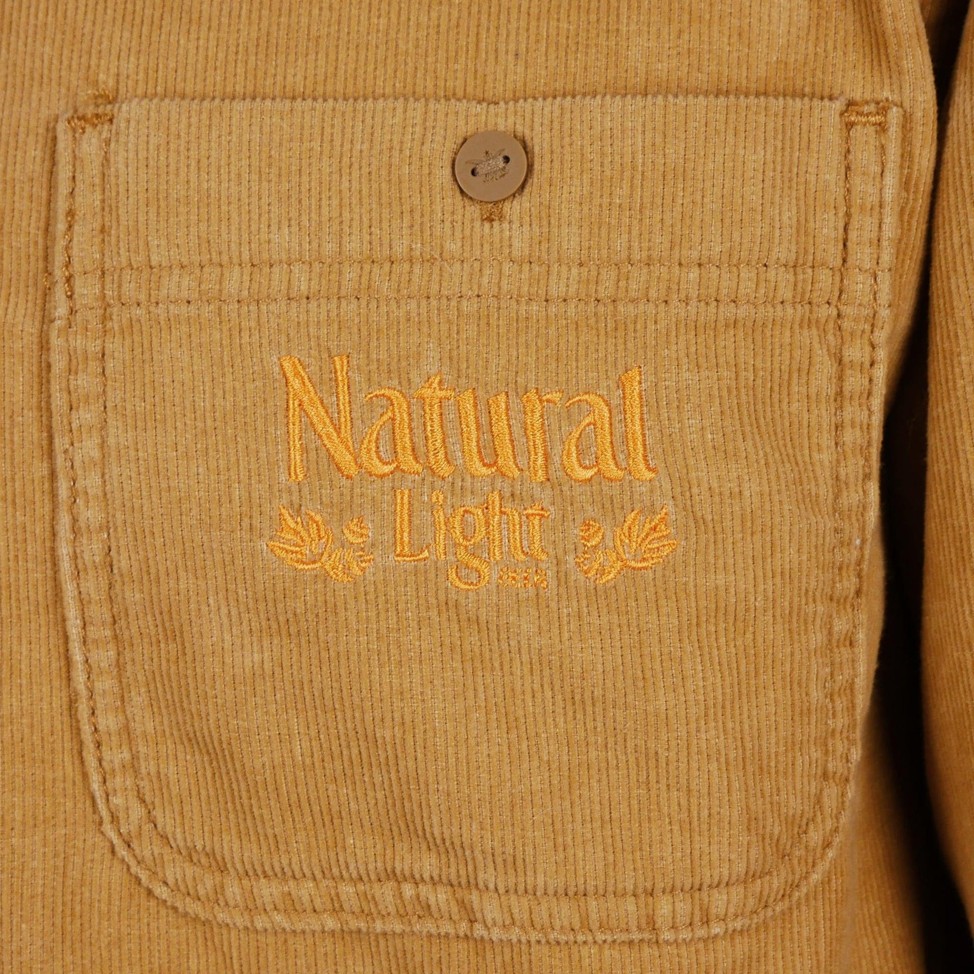 Close up of Embroidered gold Natural Light vintage logo