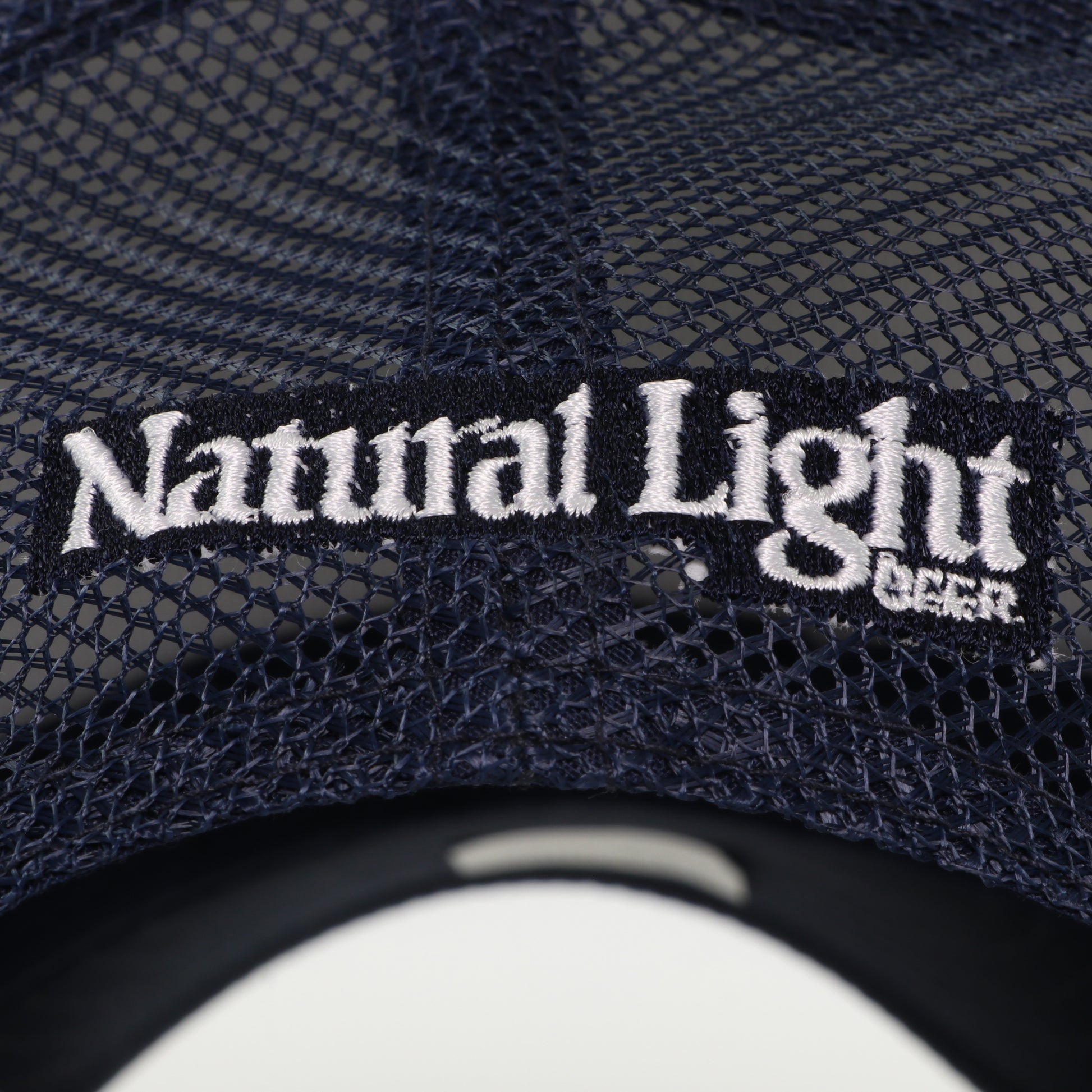 Close up of back logo on "Save Water Drink Natty" Trucker Hat