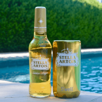 gold stella artois s'well chiller poolside with bottle of stella artois lager
