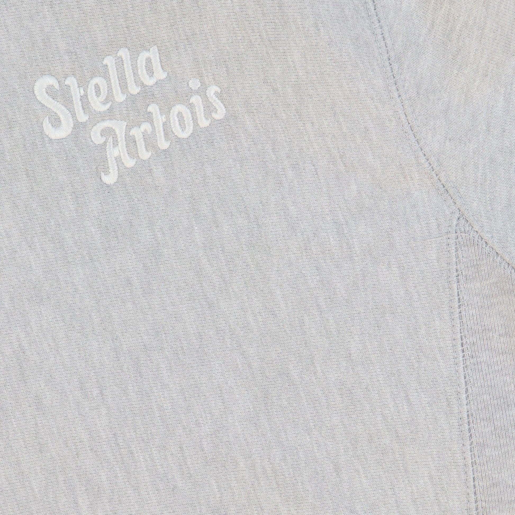 Close up of white embroidered Stella Artois logo 